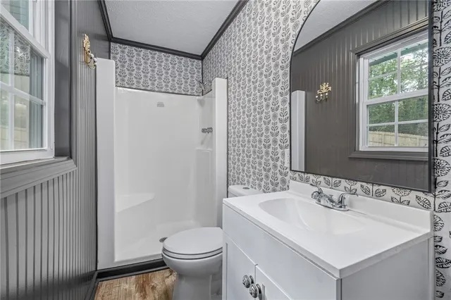 a view of a white house with a yard and garage