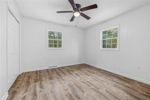 a big yard with lots of green space and house in the back