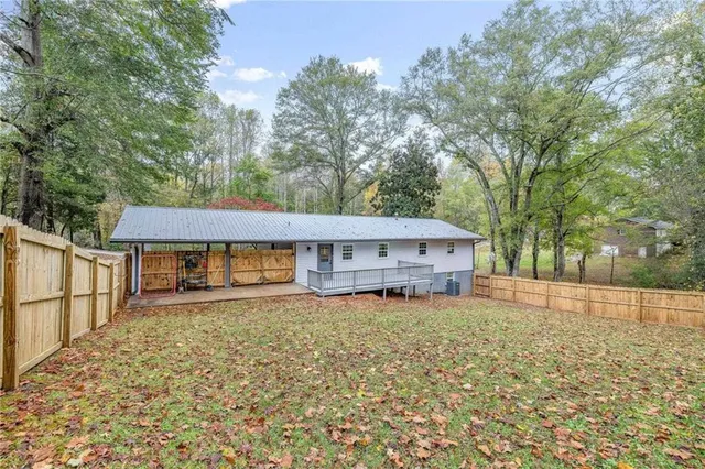 an aerial view of residential houses with outdoor space and trees