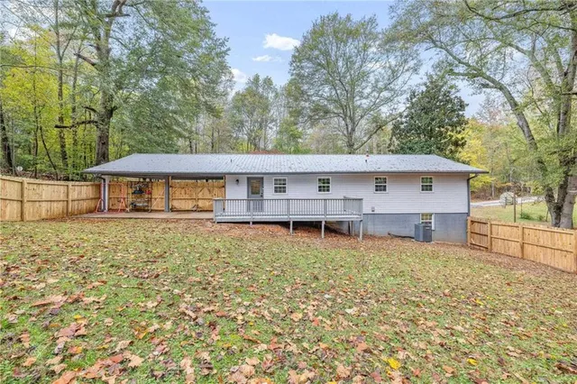 an aerial view of residential houses with outdoor space and trees