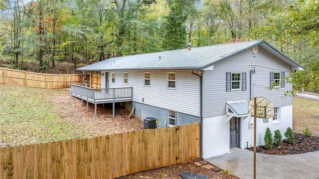 an aerial view of a house with a yard and lake view
