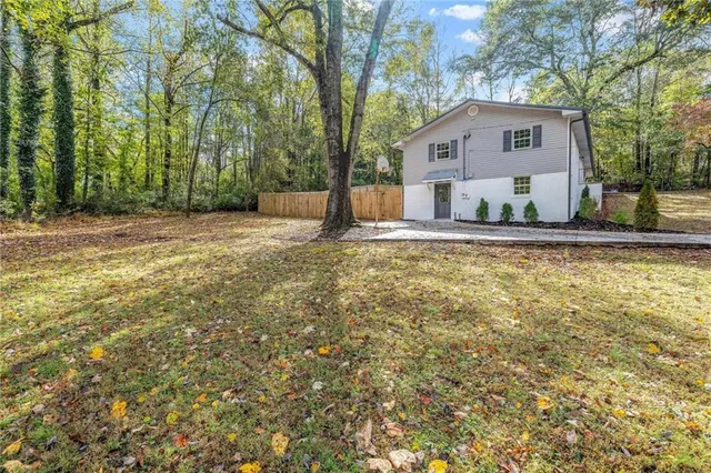 an aerial view of a house with a yard