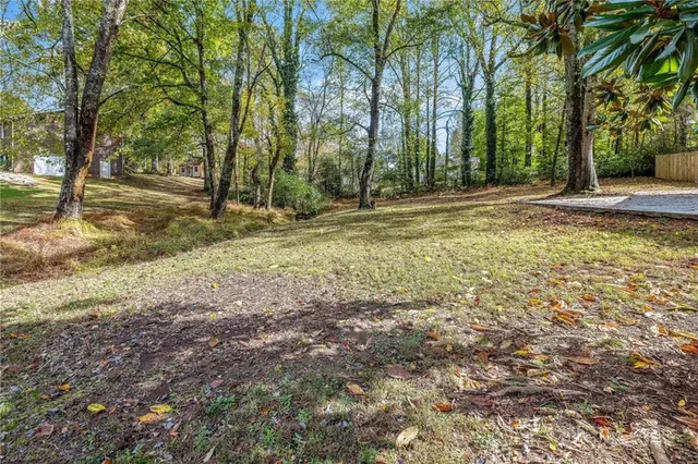 an aerial view of a houses with a yard
