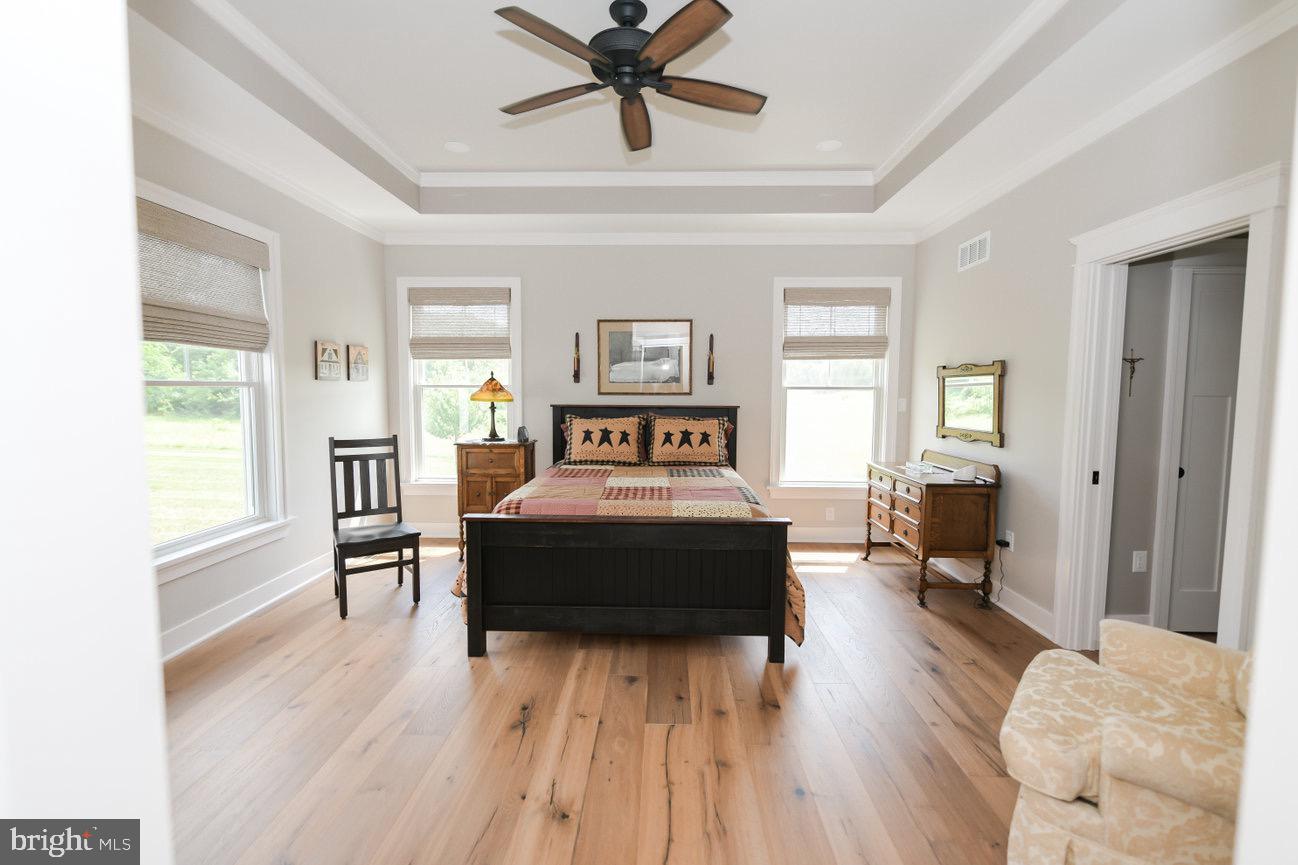 7091 Schoolhouse Road Hershey, PA 17033 - Photo 20 of 37 a bedroom with a bed and wooden floor