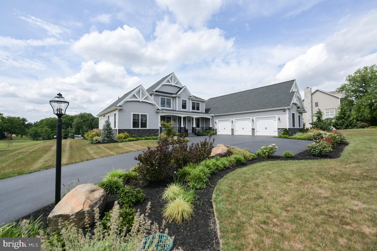 7091 Schoolhouse Road Hershey, PA 17033 - Photo 2 of 37 a front view of a house with garden