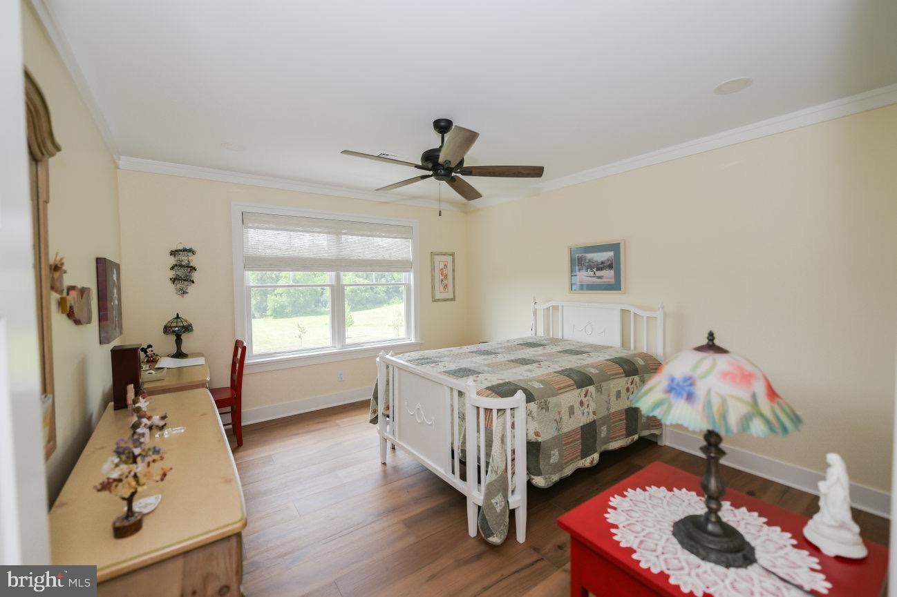 7091 Schoolhouse Road Hershey, PA 17033 - Photo 27 of 37 a bedroom with a bed and a chandelier