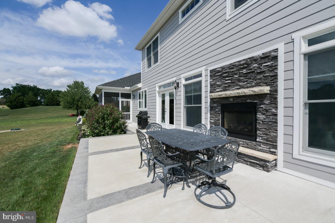 7091 Schoolhouse Road Hershey, PA 17033 - Photo 34 of 37 a patio with a table and chairs and a barbeque