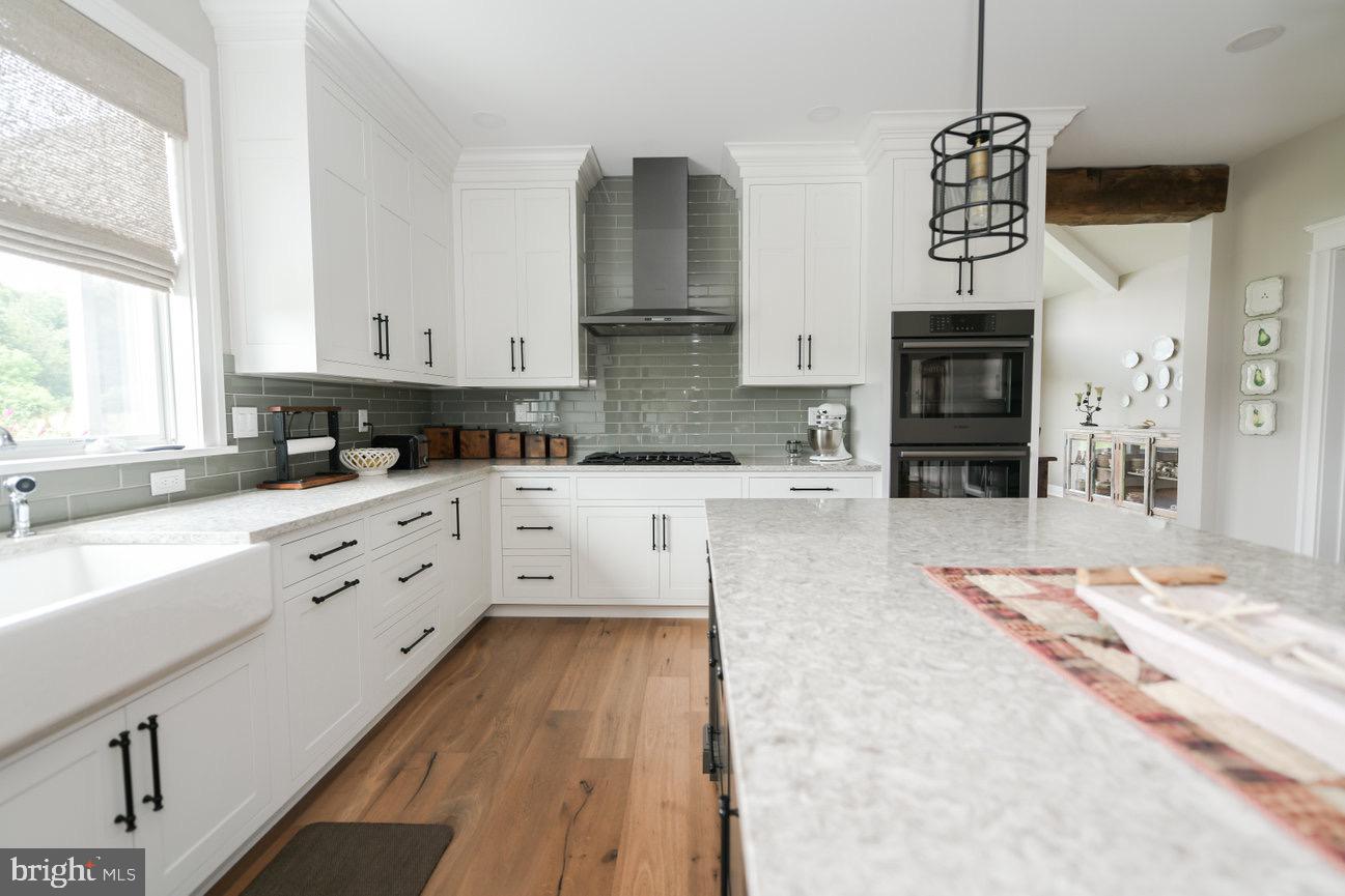 7091 Schoolhouse Road Hershey, PA 17033 - Photo 7 of 37 a kitchen with granite countertop a stove a sink and a granite counter tops