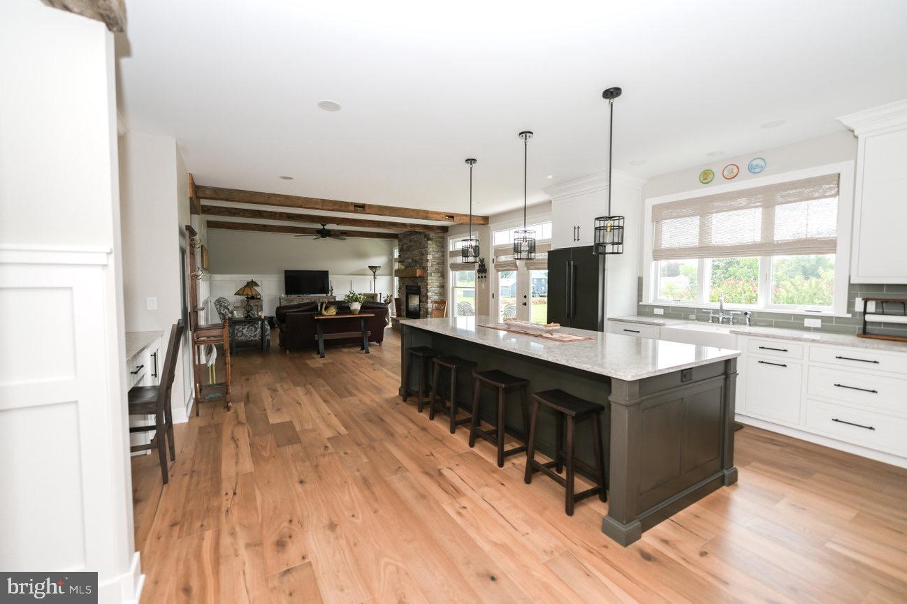 7091 Schoolhouse Road Hershey, PA 17033 - Photo 9 of 37 a kitchen with stainless steel appliances granite countertop a stove a sink and a wooden floors