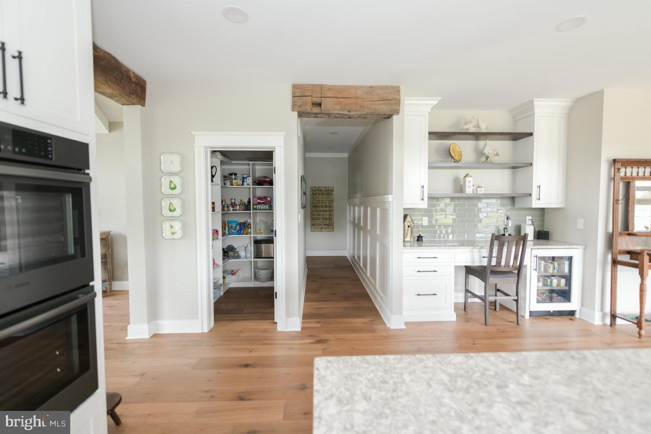 7091 Schoolhouse Road Hershey, PA 17033 - Photo 10 of 37 a view of living room kitchen with furniture and wooden floor