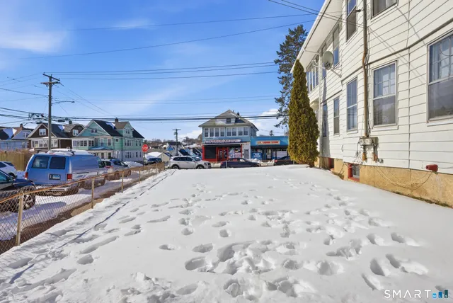 a white and red car parked in front of a building