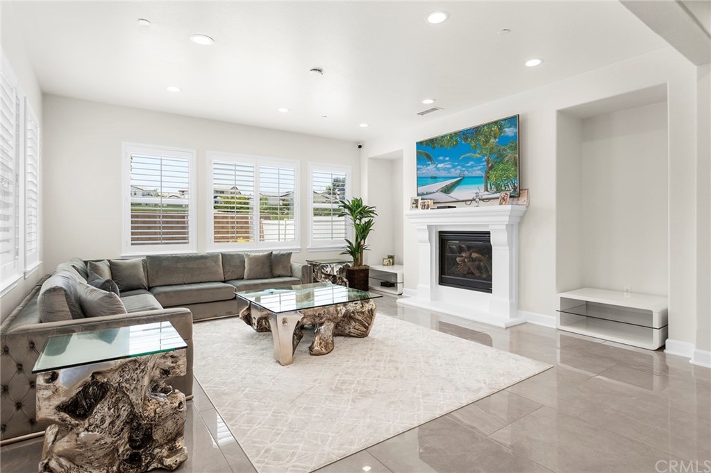45675 Bassett Street Temecula, CA 92592 - Photo 1 of 1 a living room with furniture a flat screen tv and a fireplace