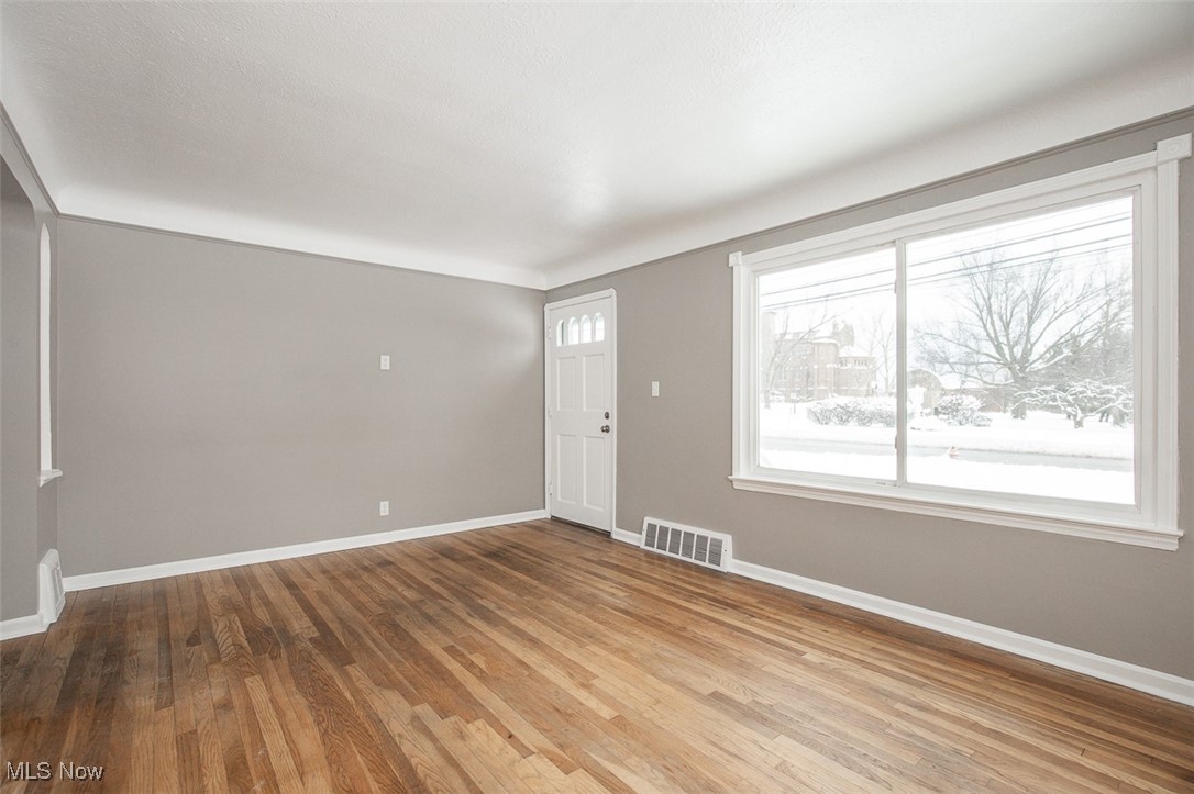 12328 Granger Road Cleveland, OH 44125 - Photo 6 of 37 Entrance foyer featuring baseboards and light wood-style flooring