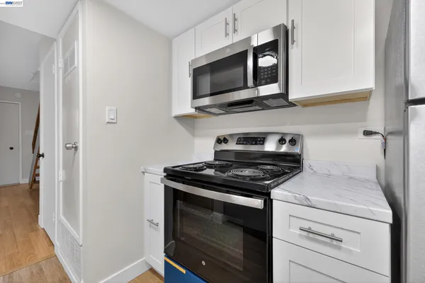 a kitchen with a stove and a microwave