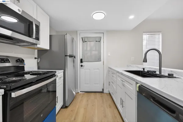 a kitchen with stainless steel appliances granite countertop a stove and a sink