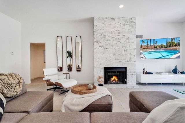 a living room with furniture and fireplace