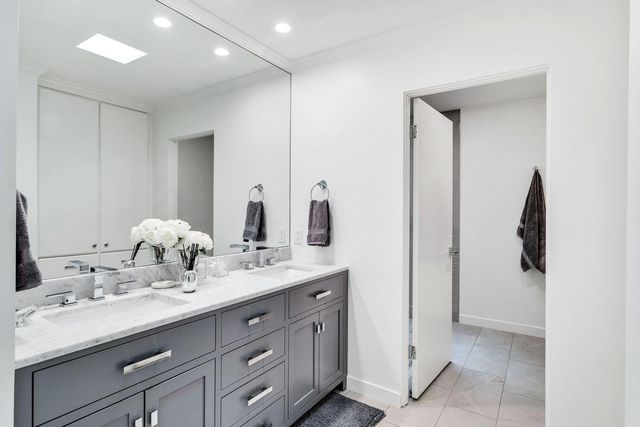 a bathroom with a double vanity sink and a mirror