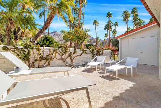 a view of a patio with table and chairs and potted plants