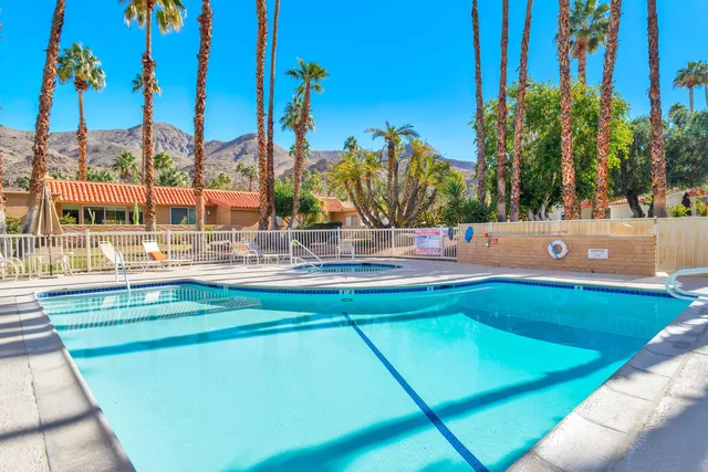 a swimming pool with outdoor seating and yard