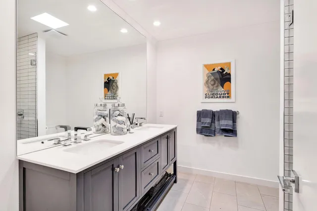 a bathroom with a sink double vanity and a mirror