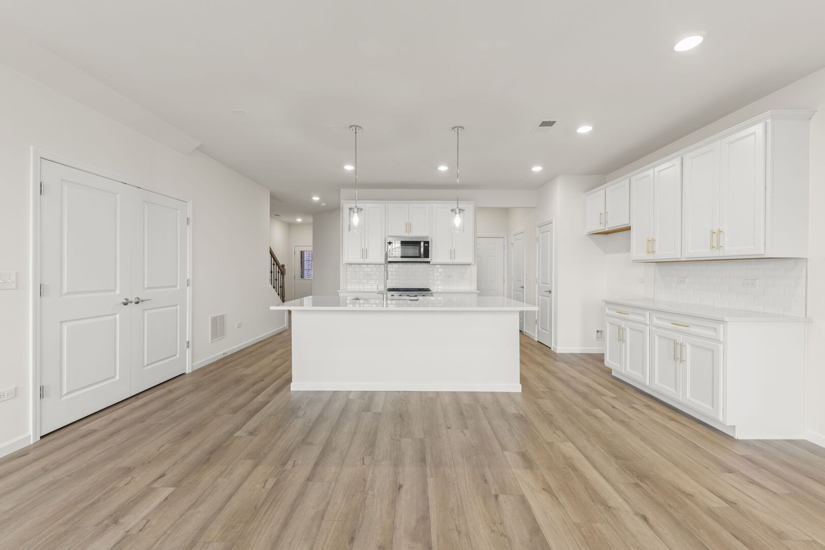 664 Switchgrass Way Bolingbrook, IL 60490 - Photo 8 of 35 a view of kitchen with kitchen island sink refrigerator and white cabinets