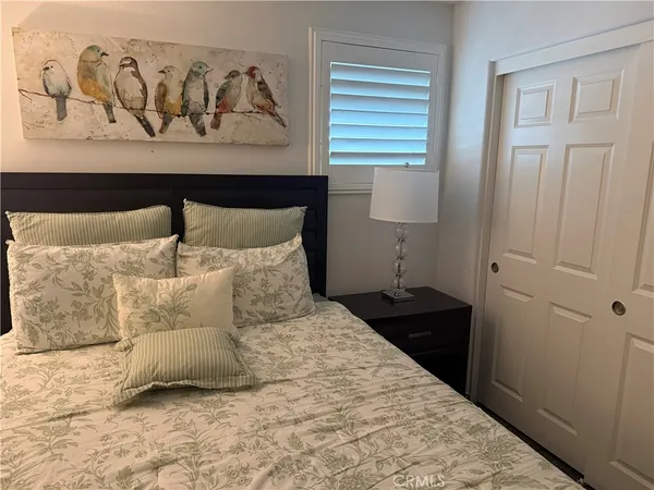 a large bed sitting in a bedroom next to a window