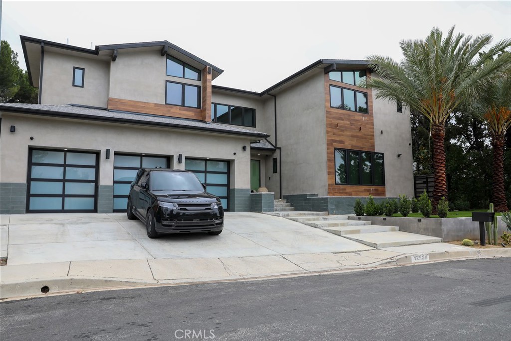12664 McLennan Avenue Granada Hills, CA 91344 - Photo 1 of 61 a car parked in front of a white building