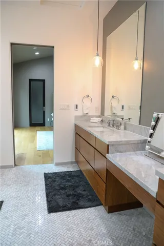 a large bed sitting in a bedroom next to a window