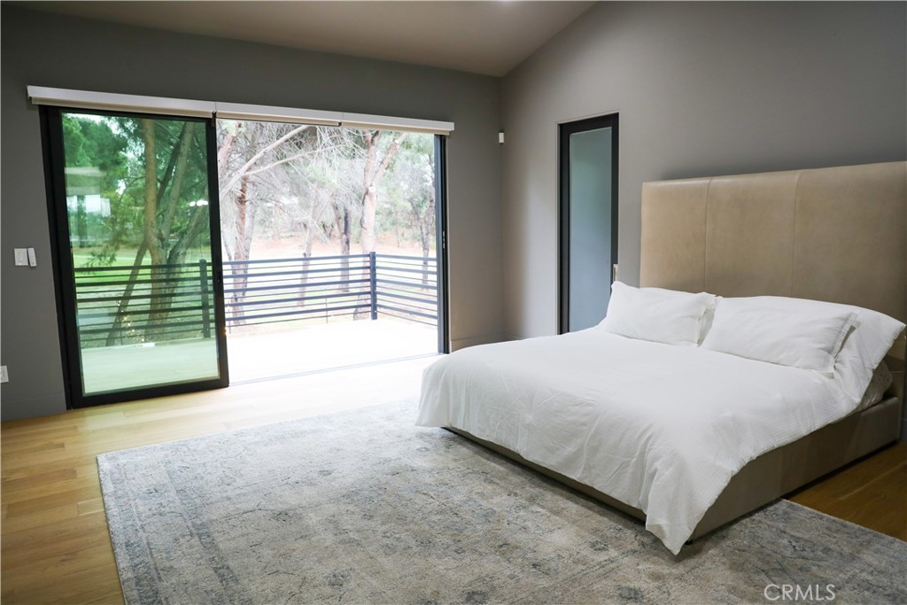 12664 McLennan Avenue Granada Hills, CA 91344 - Photo 18 of 61 a bedroom with a large bed and a large window