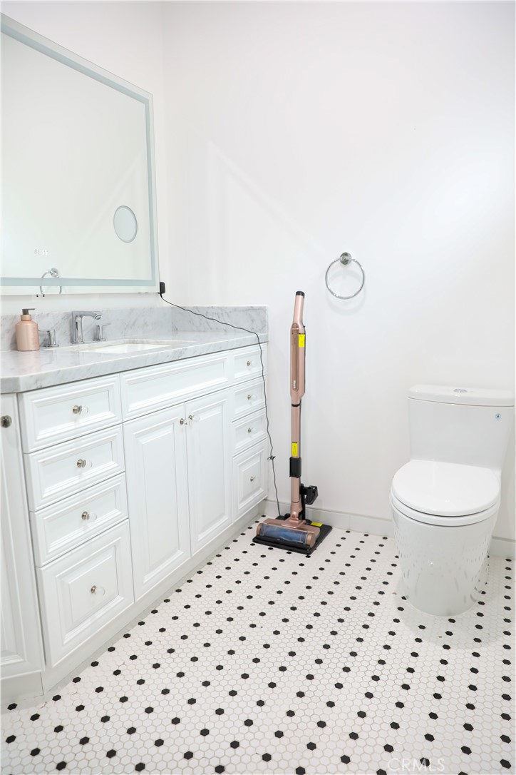 12664 McLennan Avenue Granada Hills, CA 91344 - Photo 25 of 61 a bathroom with a sink a toilet a mirror and shower