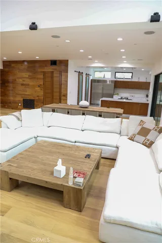 a dining hall with stainless steel appliances granite countertop a table chairs and a refrigerator