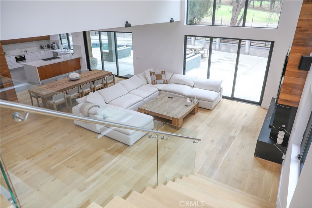 12664 McLennan Avenue Granada Hills, CA 91344 - Photo 36 of 61 a living room with furniture and a floor to ceiling window
