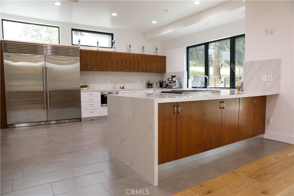 12664 McLennan Avenue Granada Hills, CA 91344 - Photo 45 of 61 a kitchen with stainless steel appliances granite countertop a refrigerator and a sink