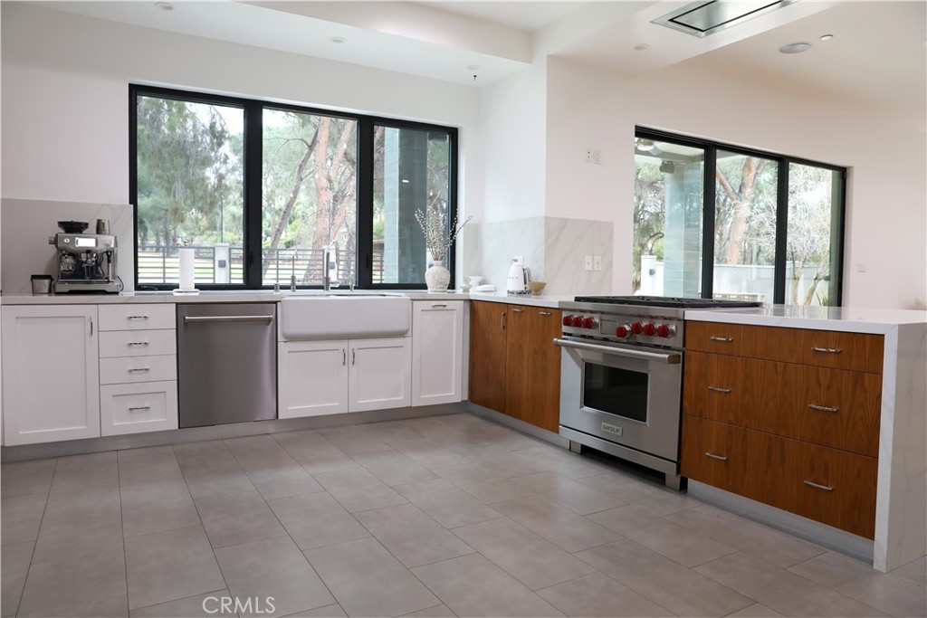 12664 McLennan Avenue Granada Hills, CA 91344 - Photo 46 of 61 a kitchen with stainless steel appliances granite countertop a stove and a sink