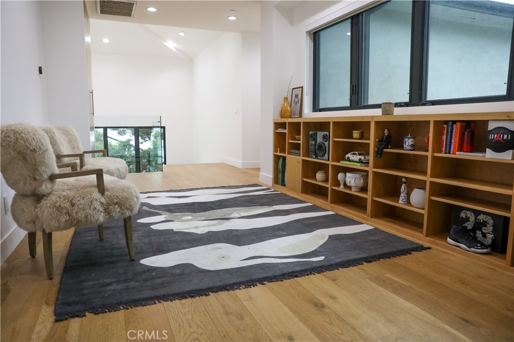 12664 McLennan Avenue Granada Hills, CA 91344 - Photo 9 of 61 a living room with a bed and a wooden floor