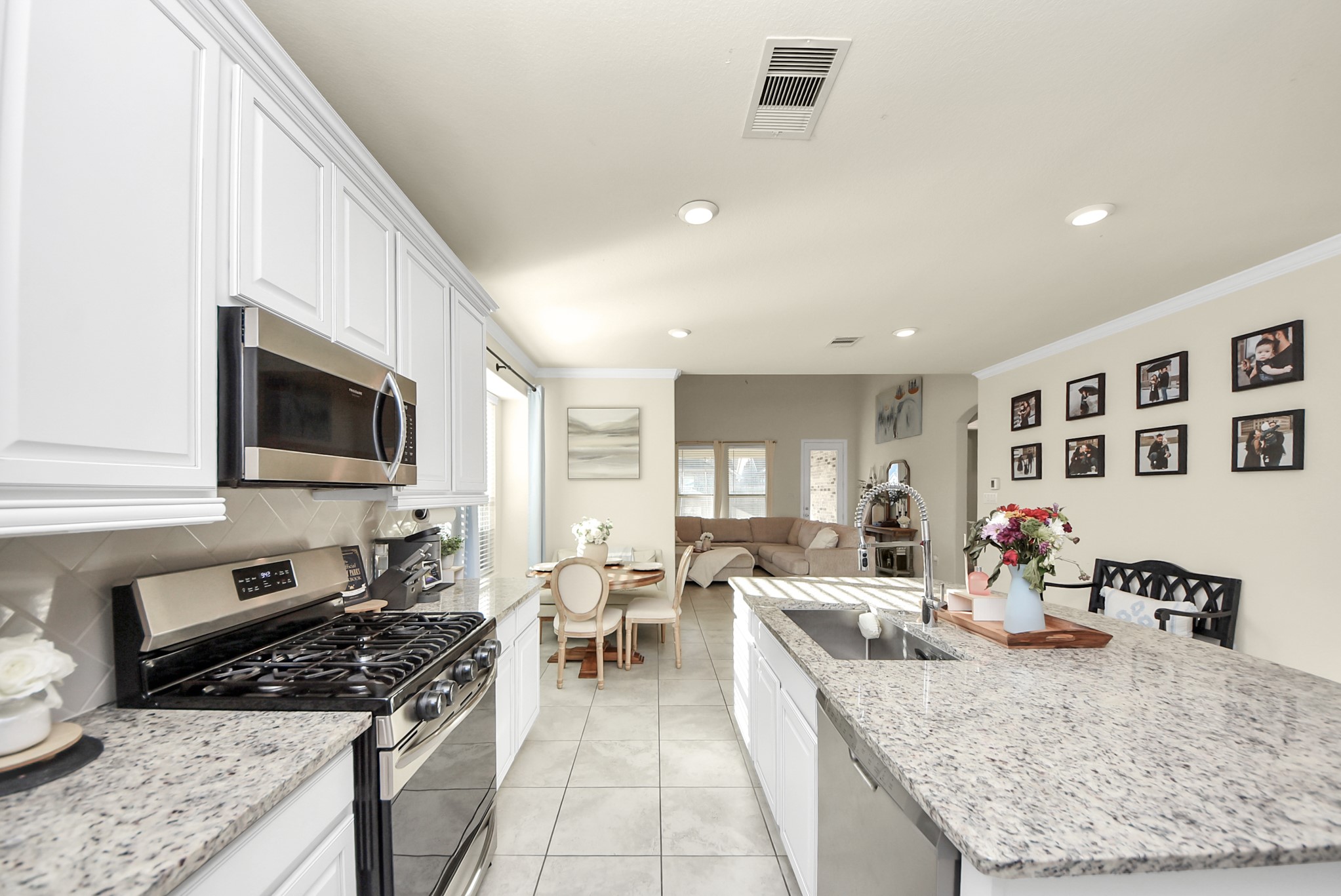 6703 Sandia Crest Street Spring, TX 77379 - Photo 11 of 45 a large kitchen with stainless steel appliances granite countertop a lot of counter space and a sink