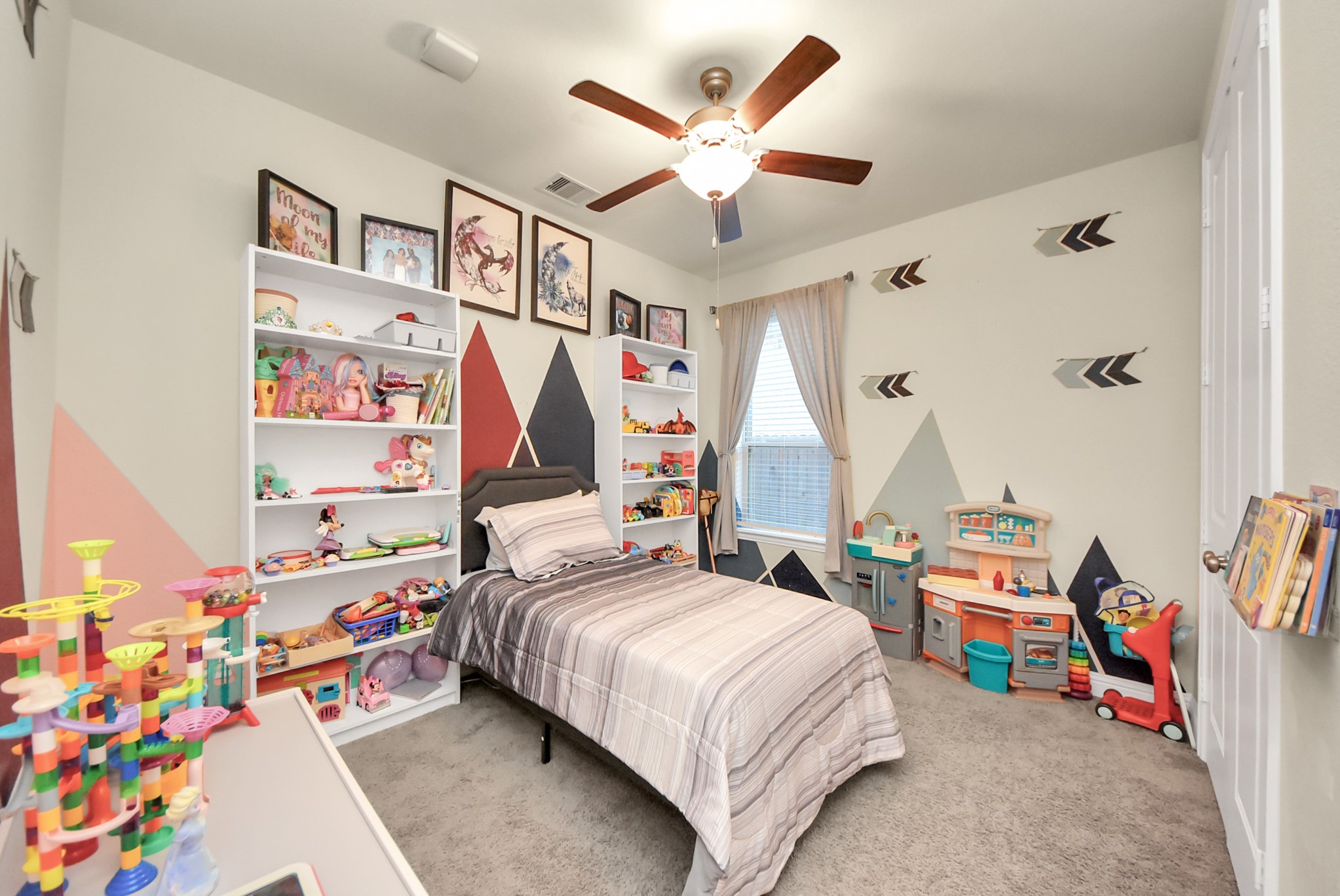 6703 Sandia Crest Street Spring, TX 77379 - Photo 23 of 45 a bedroom with a bed and a chandelier