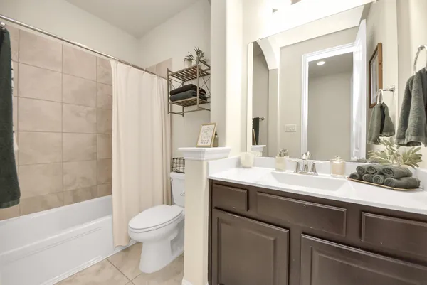 a spacious bedroom with a bed and a couch