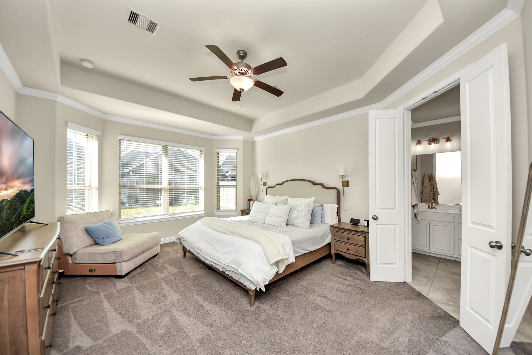 6703 Sandia Crest Street Spring, TX 77379 - Photo 25 of 45 a spacious bedroom with a bed and a couch
