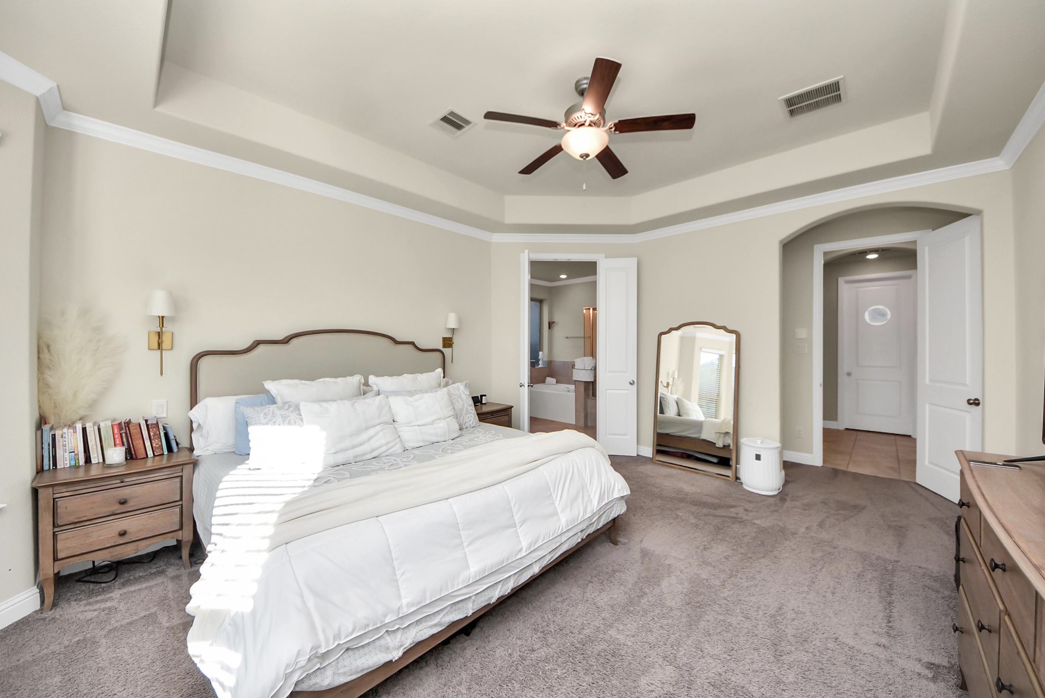 6703 Sandia Crest Street Spring, TX 77379 - Photo 26 of 45 a bedroom with a bed a ceiling fan and a dresser