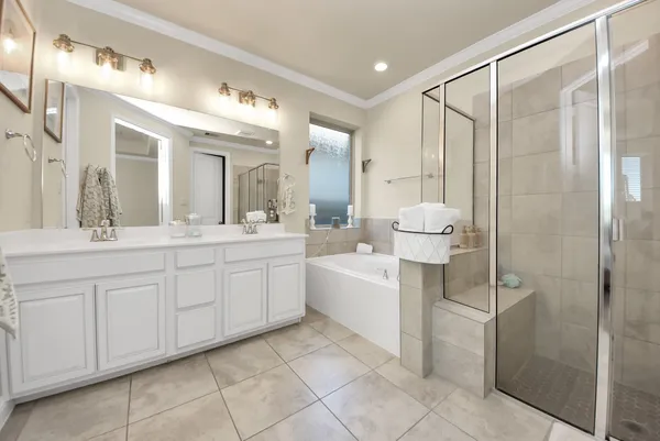 a bathroom with a double vanity sink and a mirror