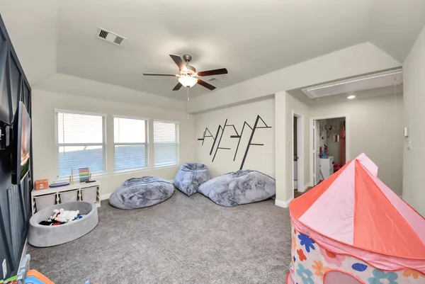 a bedroom with furniture and a ceiling fan