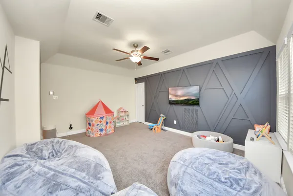 a bed room with a bed and a chandelier