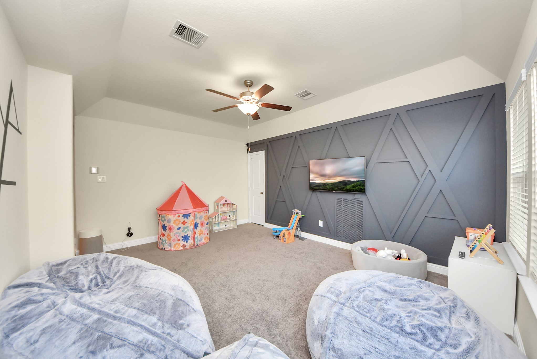 6703 Sandia Crest Street Spring, TX 77379 - Photo 33 of 45 a bedroom with furniture and a chandelier