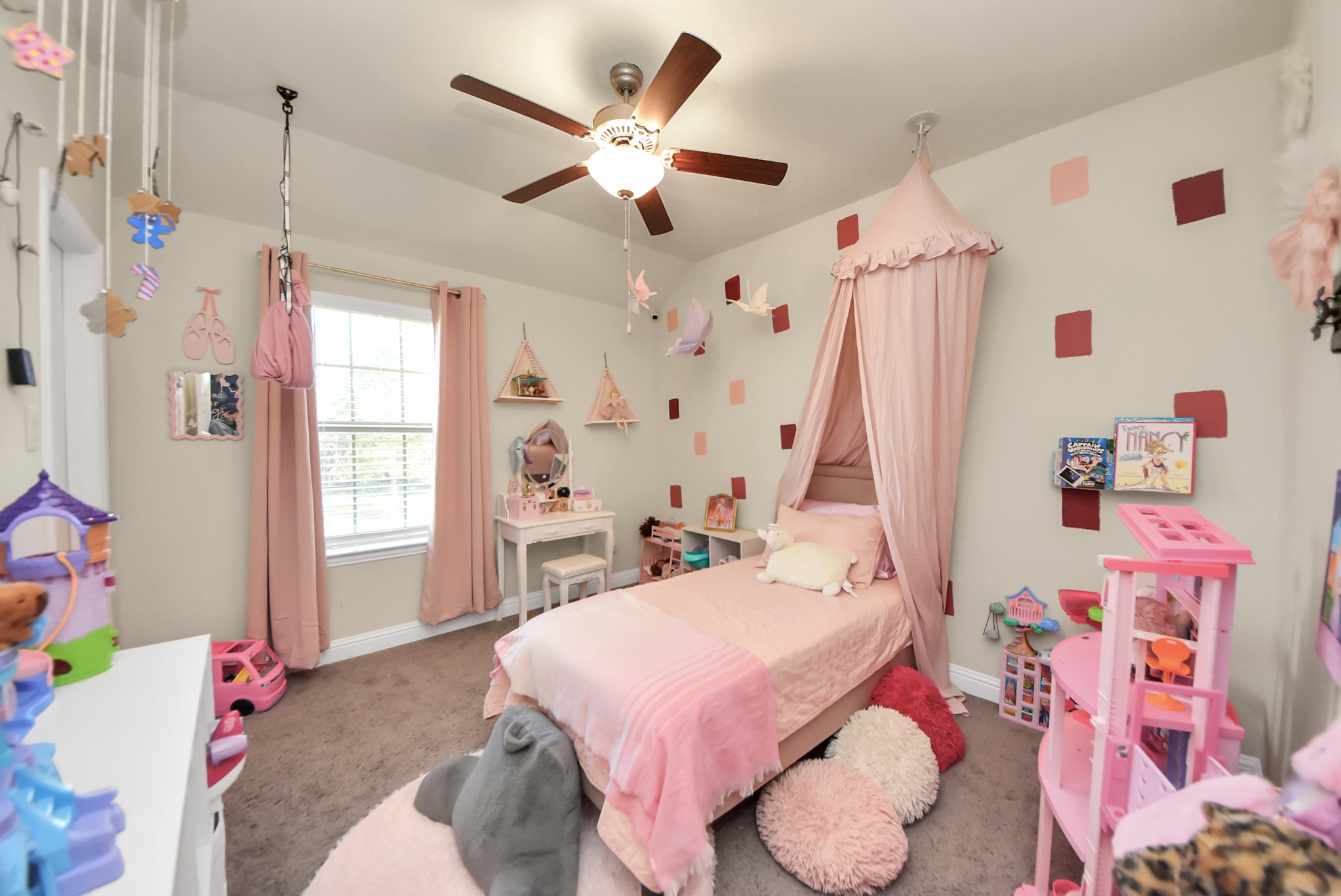 6703 Sandia Crest Street Spring, TX 77379 - Photo 34 of 45 a bed room with a bed and a chandelier