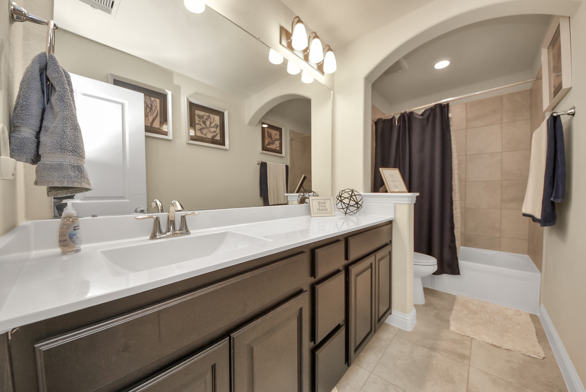 6703 Sandia Crest Street Spring, TX 77379 - Photo 35 of 45 a spacious bathroom with a double vanity sink a large mirror and a shower