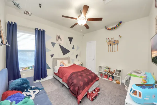 a view of a house with a backyard porch and wooden fence