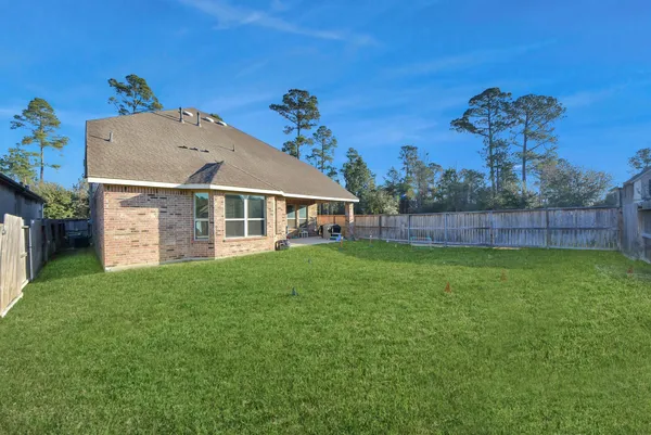 a view of a house with a backyard