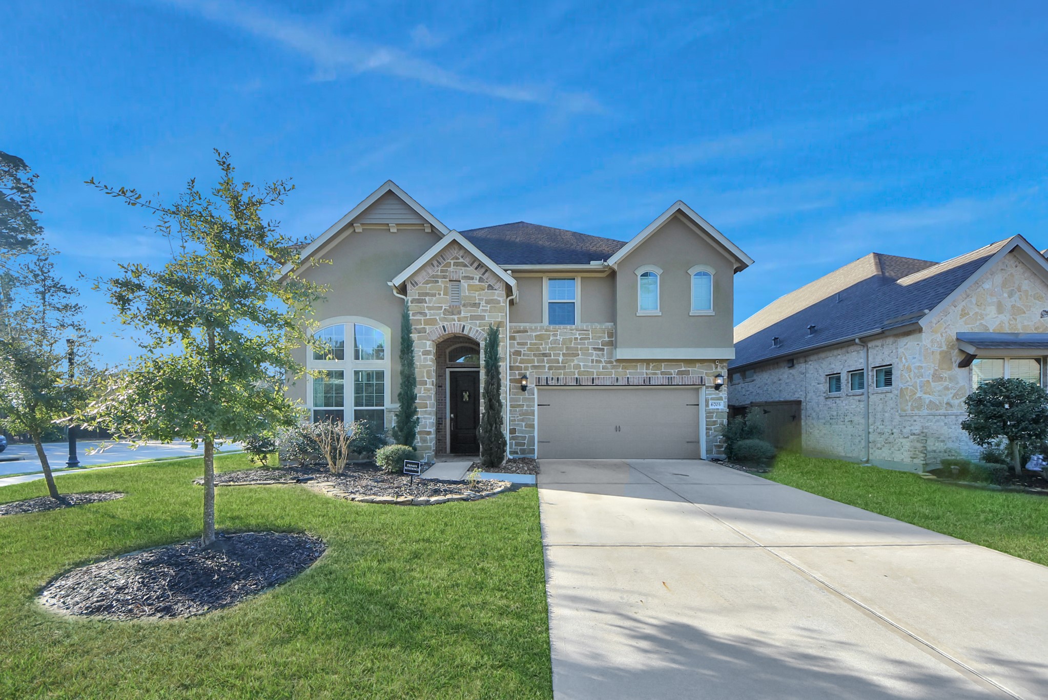 6703 Sandia Crest Street Spring, TX 77379 - Photo 44 of 45 a front view of a house with garden
