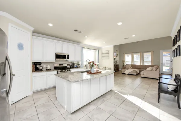 a view of a kitchen with kitchen island granite countertop lots of counter top space